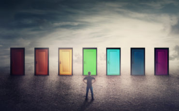 Confident guy in front of many doors different colored has to choose one
